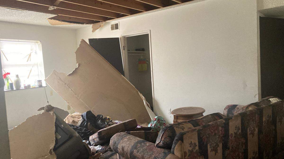 An abandoned basement apartment at the Cloverleaf Apartments where water damage from above caused the ceiling to collapse on a living room couch.