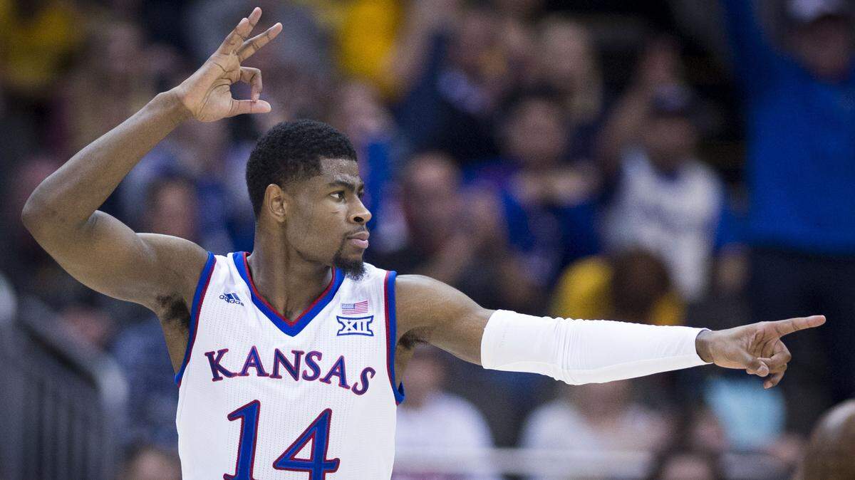 KU guard Malik Newman, the tournament's MVP, celebrated a three-pointer while acknowledging teammate Devonte' Graham for the assist in the first half of Saturday's Big 12 Tournament championship game at the Sprint Center.
