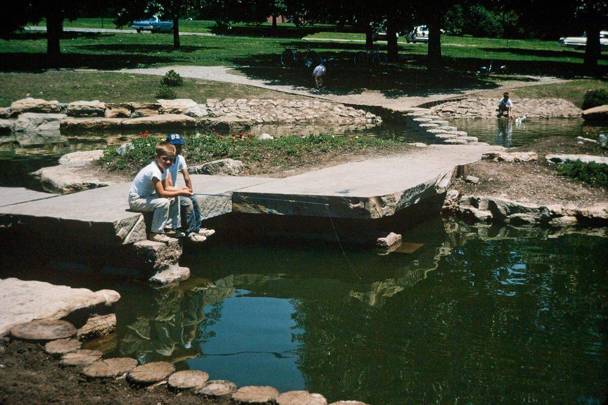 Two children fish at the duck pond in Loose Park. 1965.