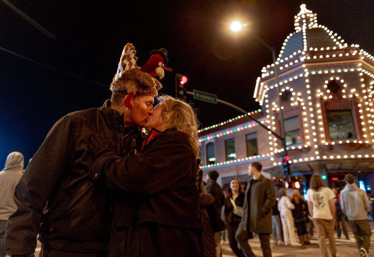 Patty Scholten of Garden City, Missouri, kisses her husband Chris after holiday lights were switched on at the Country Club Plaza during the 93rd annual Thanksgiving night lighting ceremony on Thursday, Nov. 24, in Kansas City. 