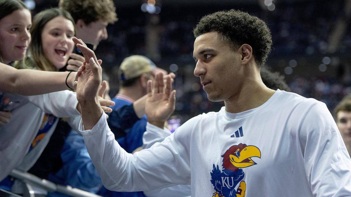 Kansas guard Kevin McCullar Jr. high-fives fans before the Big 12 Tournament championship game against Texas Saturday, March 11, 2023, in Kansas City.