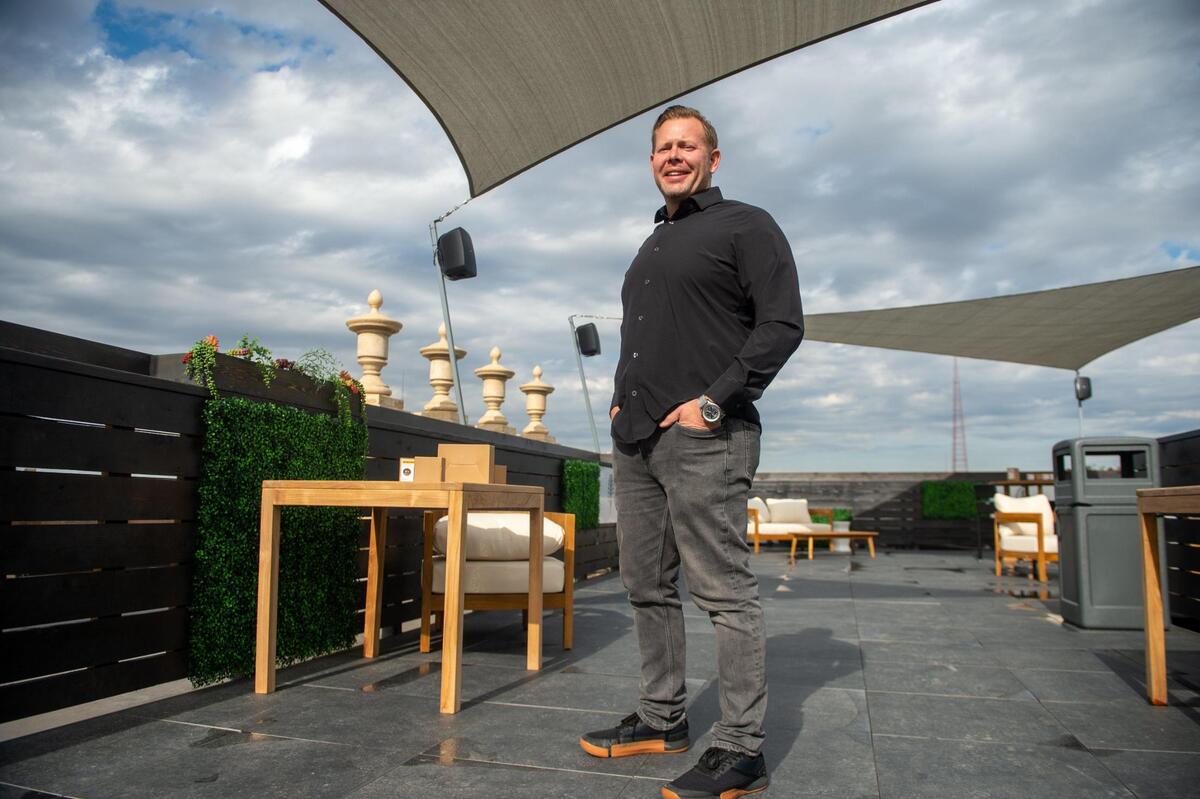 Caleb Buland, a Kansas City architect with Exact Partners LLC, stands on the rooftop bar of the Netherland building at 3835 Main St. in Kansas City.