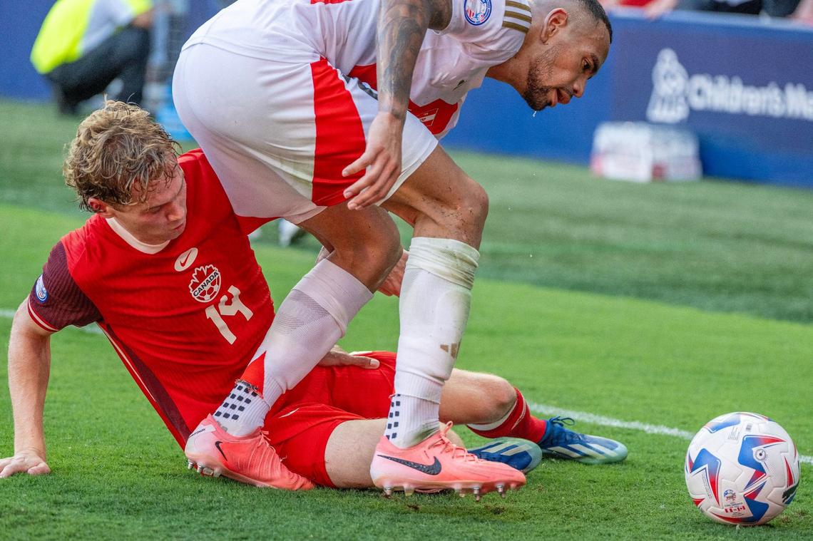 Canada forward Jacob Shaffelburg (14) attempts to steal the ball from Peru goalkeeper Carlos Cáceda (12) in the second half of a Copa America match at Children’s Mercy Park.