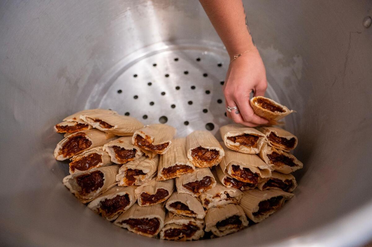 Elaina Ramirez assembles freshly wrapped tamales in a pot. Making tamales has been part of her family’s tradition during the holidays and has been passed down for three generations.