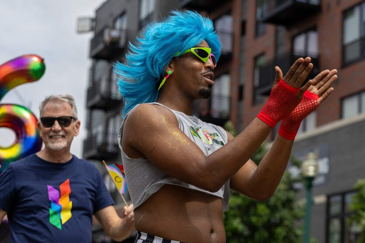 Parade attendee dance their way down the street during Kansas City's Annual Pride Parade at Westport Rd on Saturday, June 6, 2026.