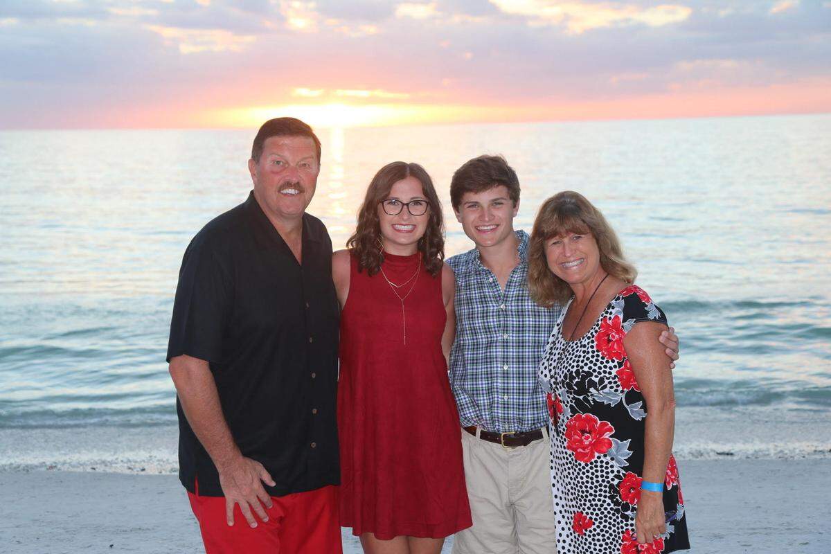 Nathan Harrell (left) and his wife Sylvia (right) with their kids Melanie and Chad (middle).