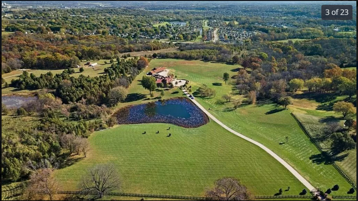 An aerial view of the house at 5401 Phelps Road in Kansas City. Here, you can see the long driveway and the pond where you can fish for catfish and crappie.