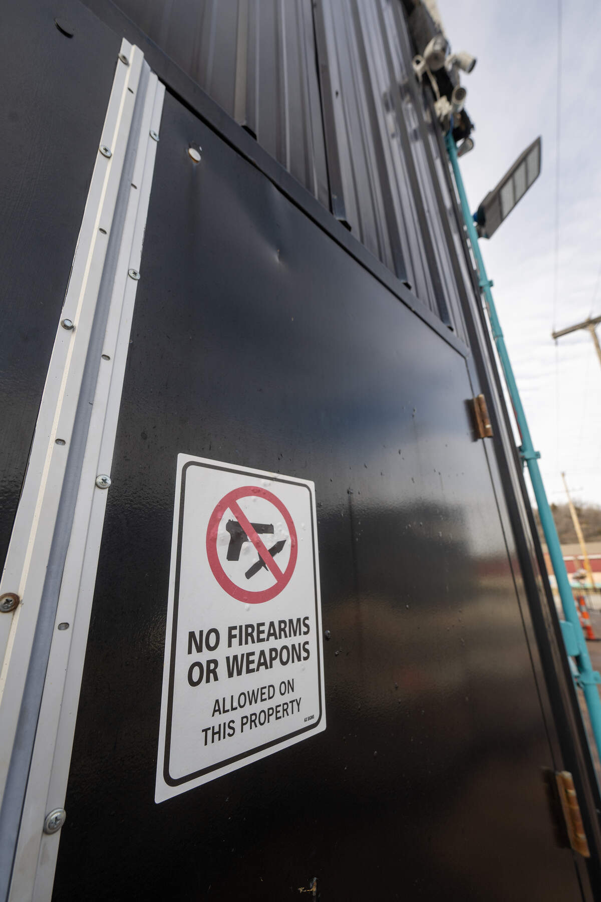 Four security cameras and signs denoting ‘No Firearms or Weapons,’  are mounted outside an entrance to Status nightclub at 2801 Southwest Blvd., on Monday, Feb. 16, 2026, in Kansas City. Two women were fatally shot and two other people were injured in a shooting at the night club on Sunday, Feb. 15, 2026.