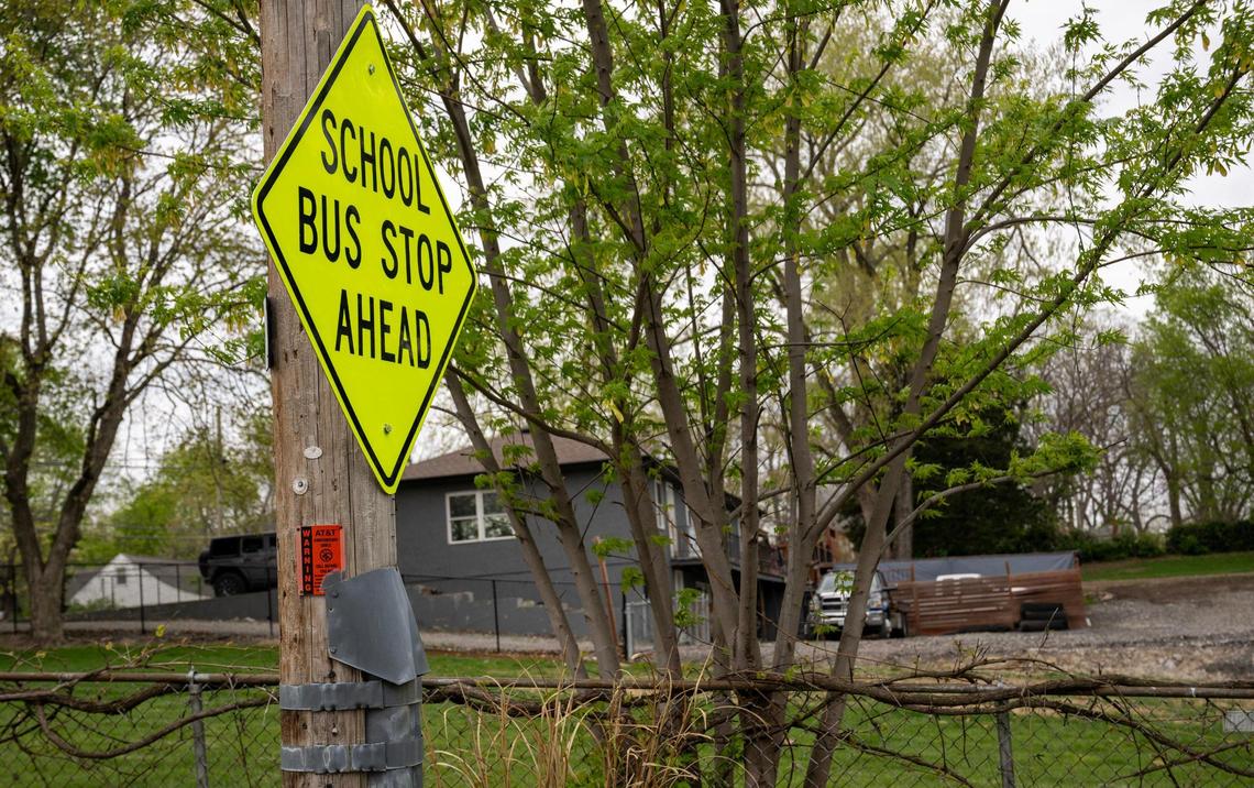 A sign denotes a school bus stop near a home in the 3700 block of N.E. Russell Rd., in the Chaumiere neighborhood on Wednesday, April 15, 2025. The neighborhood, which has had some issues with dogs, is located north of the river in Kansas City.