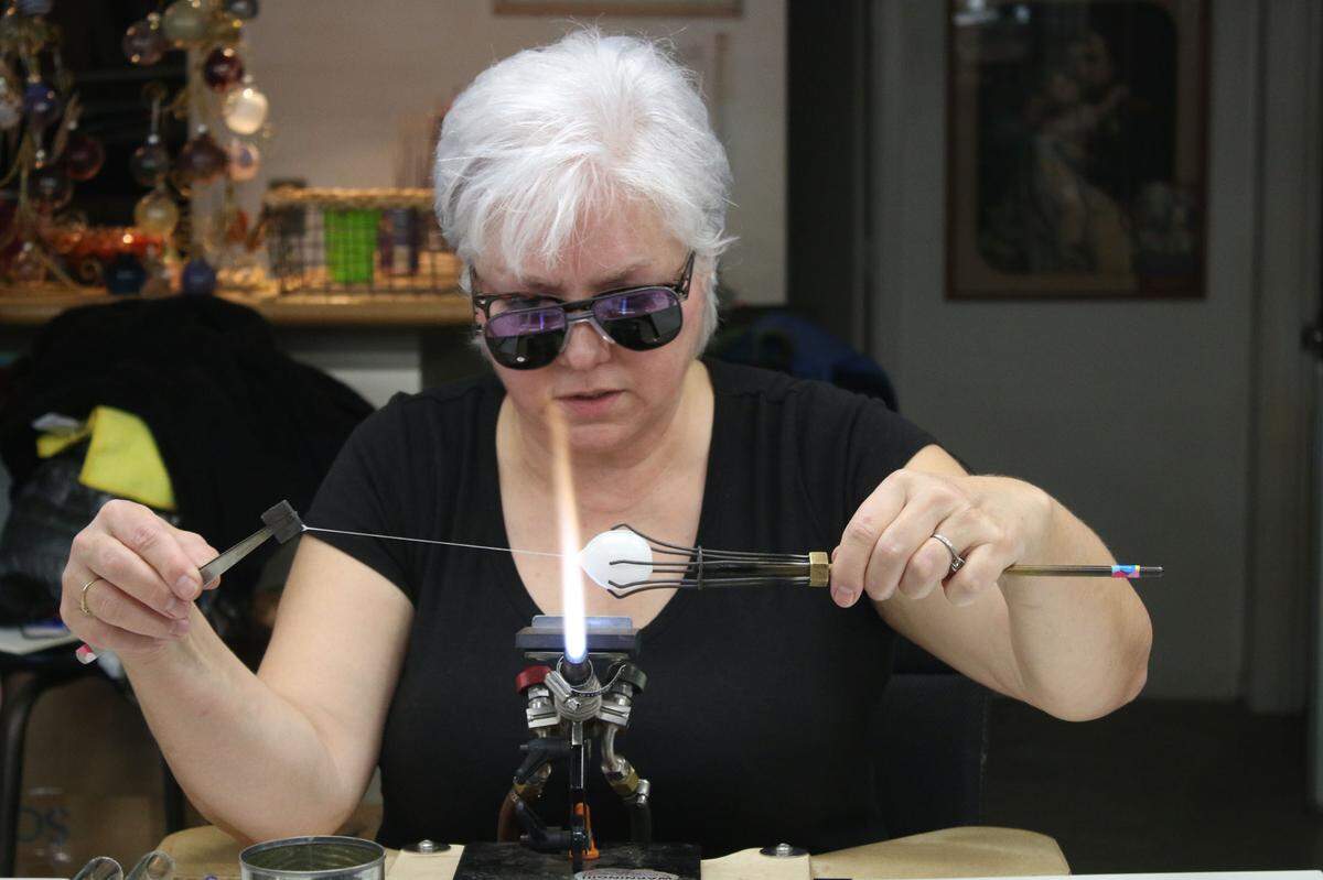 Artist Kathleen Elliot teaches a master class on how to make glass shaped like fruit at Public Glassworks KC in Lenexa.