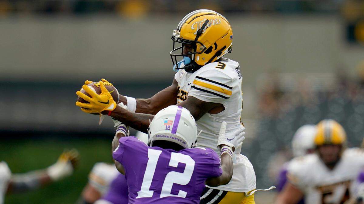 Missouri Tigers’ wide receiver Luther Burden III catches a pass over Abilene Christian defensive back Triston Anderson on Saturday in Columbia.
