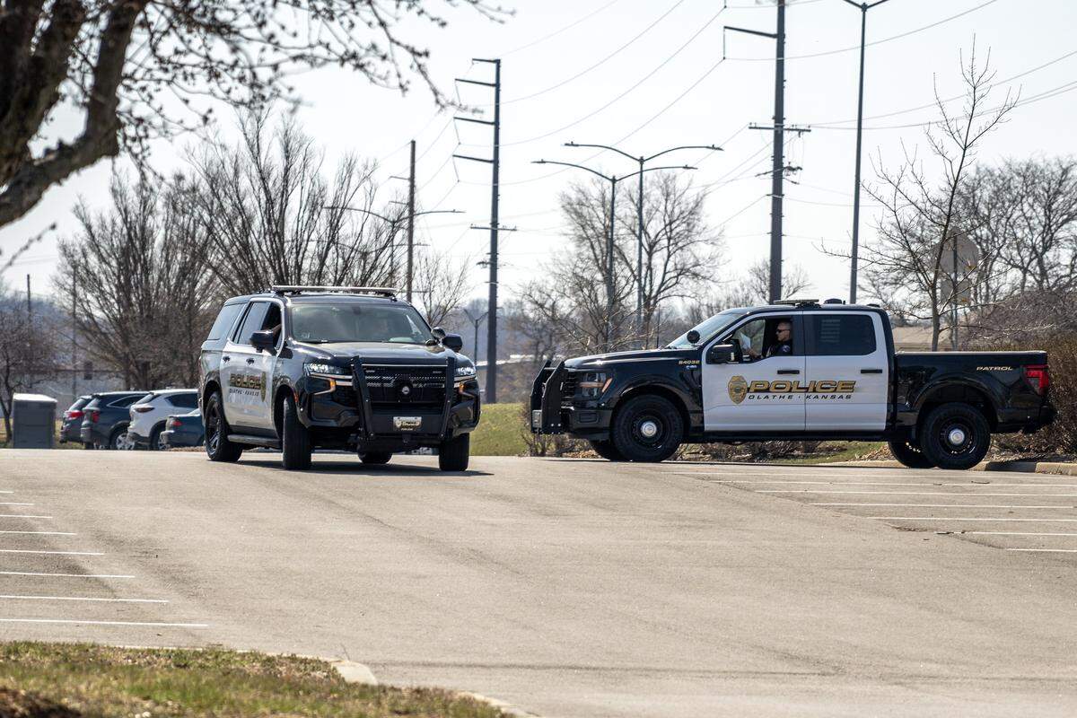 Olathe Police vehicles are seen stationed at Two Trails Park on Friday, March 20, 2026, in Olathe.