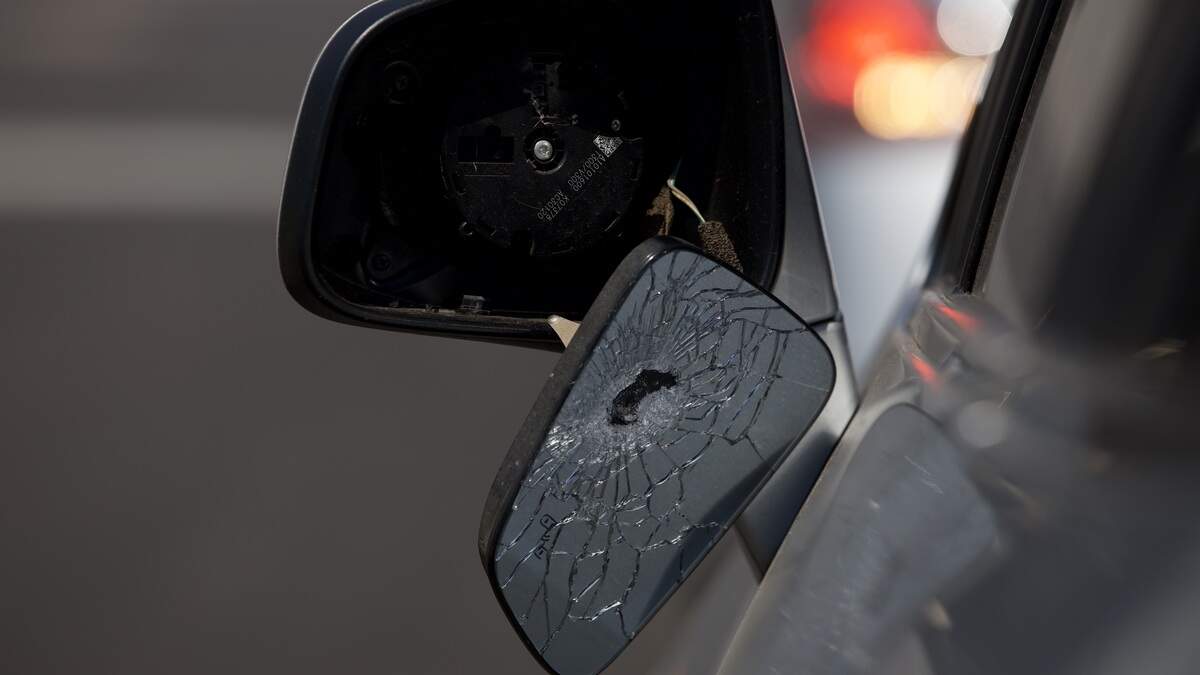 A car mirror appears to have been shot while parked at 19th and Vine streets on Saturday, June 20. Police said several people were injured and one man was killed in a shooting in the area the night before.