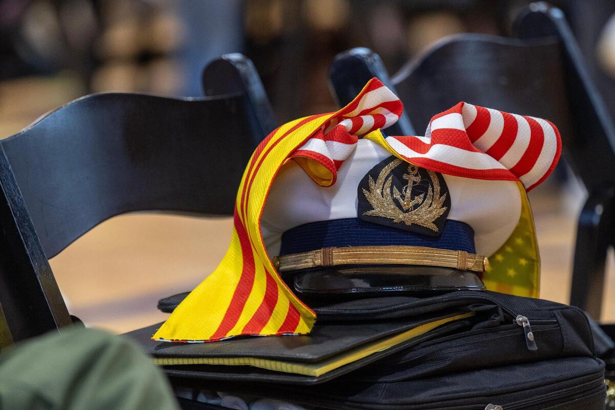 The hat of Ty Bui, 77, of Overland Park, rests on a chair during “Remembering Saigon’” The event marked the 50th anniversary of the end of the Vietnam War and the resulting mass exodus of South Vietnamese individuals, many of whom, including Bui, who found a new home in Kansas City. Sponsorship for the remembrance was provided by the Vietnamese American Community of Greater Kansas City and Hella Good Deeds. Bui, Chairman of the Vietnamese Officers Club, was a former captain in the South Vietnamese Navy.