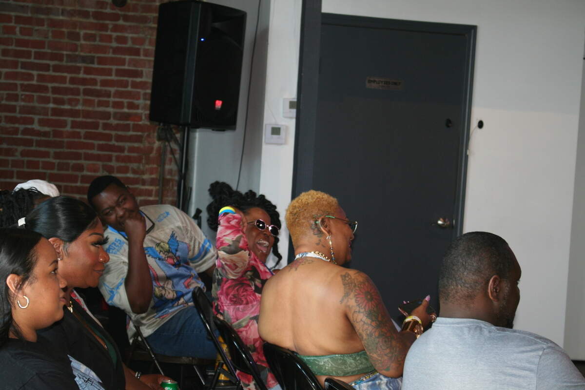 Attendees at the Fit Check Fashion Show by Kansas City Hip Hop Week react to the designs.