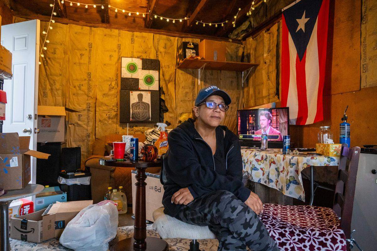 Leticia Rodriguez in her garage at Aspen Place Apartments in Gardner on Wednesday, May 7, 2025. Residents were forced to move in 48 hours after the city condemned the entire apartment complex due to several dangerous factors. Rodriguez, a single mother originally from Chicago, said she was heartbroken to have to leave her community. “We’re a family.”