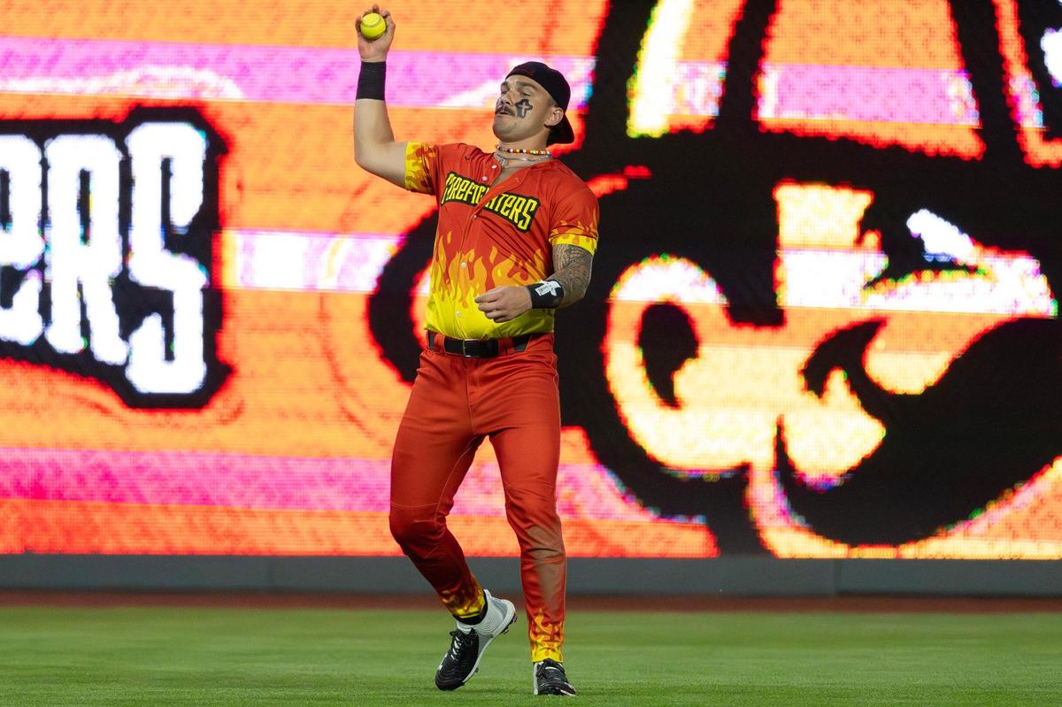 Firefighters utility player Mason Maxwell catches a pop-up with his bare hand in the eighth inning during a Banana Ball game against the Savannah Bananas at Kauffman Stadium on Friday, May 23, 2025, in Kansas City.