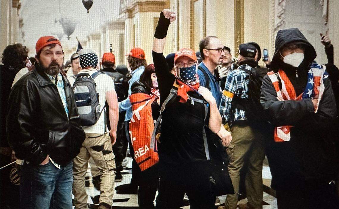 Prosecutors say Christopher Roe stood in the middle of a Capitol hallway with his fist in the air after breaching the building on Jan. 6, 2021.