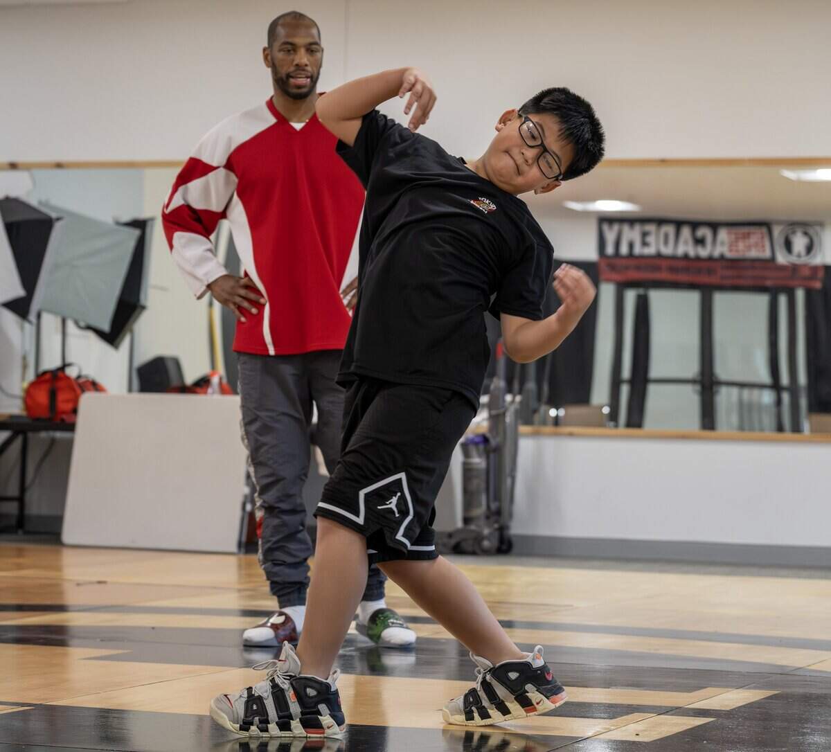 Dance instructor Zonte Warren coaches Hunter Nguyen through a dance move during Street Stylez Academy rehearsal at Hy-Vee Arena on Tuesday, Aug. 12, 2025, in Kansas City.