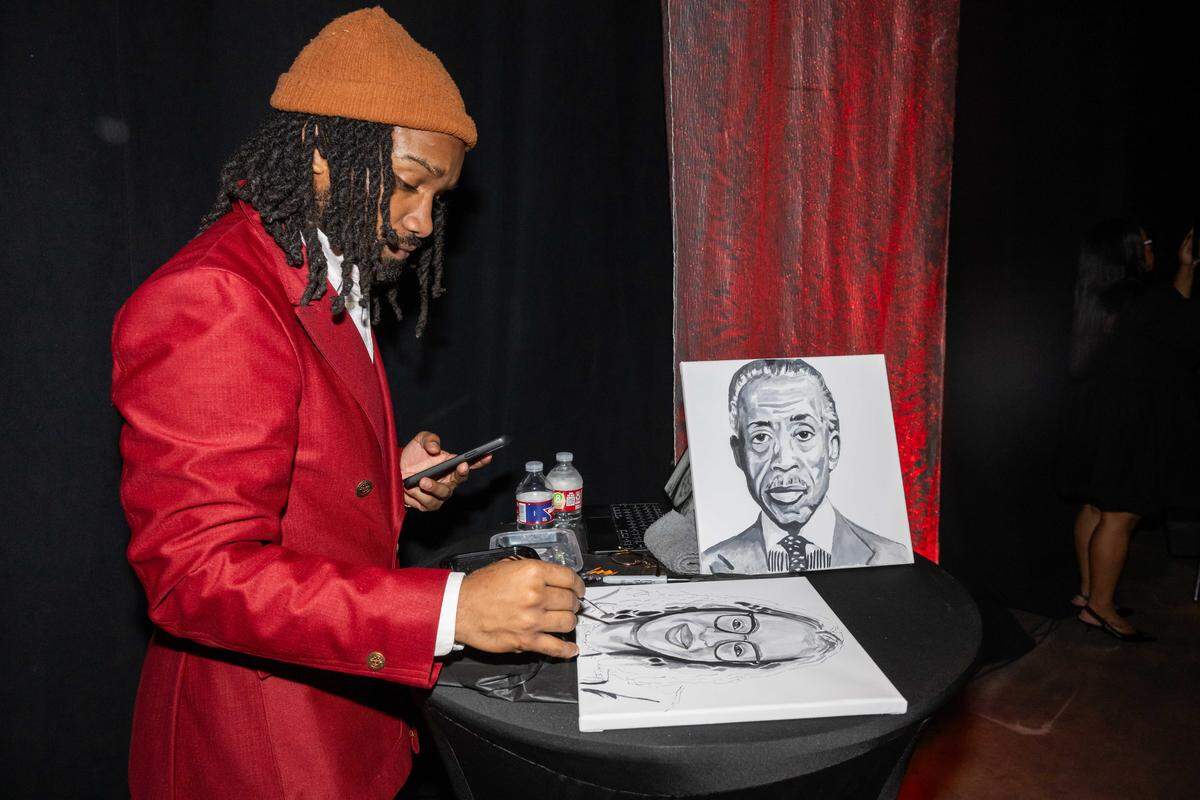 Artist Deaunte Thomas paints portraits of Rev. Al Sharpton and Urban League of Greater Kansas City CEO Gwendolyn Grant at the “Difference Maker” Awards Luncheon on Thursday, March 19, 2026, in Kansas City. Sharpton was an honored guest at the event where Grant officially announced her retirement.
