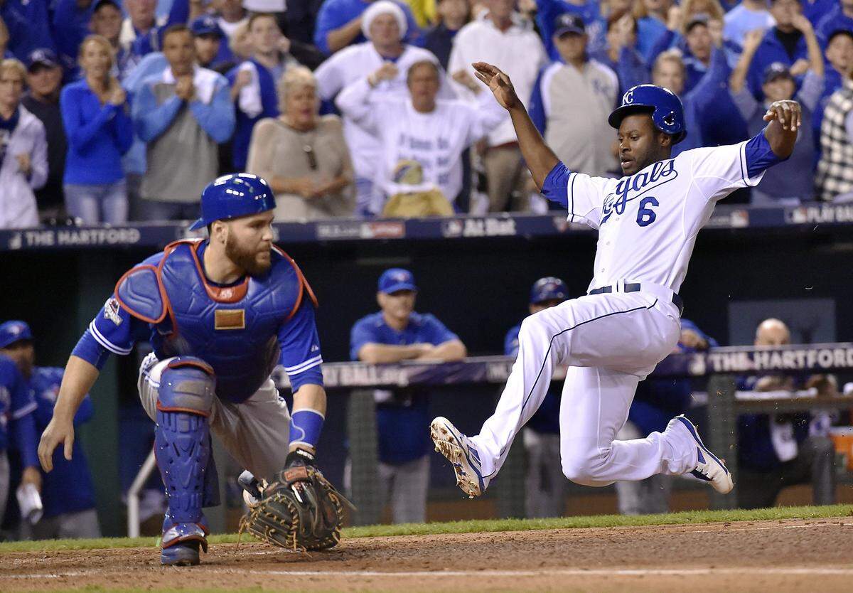 Kansas City Royals center fielder Lorenzo Cain scores past Toronto Blue Jays catcher Russell Martin on an RBI single by Kansas City Royals first baseman Eric Hosmer in the eighth inning during Friday’s ALCS baseball game on October 23, 2015 at Kauffman Stadium in Kansas City, Mo.