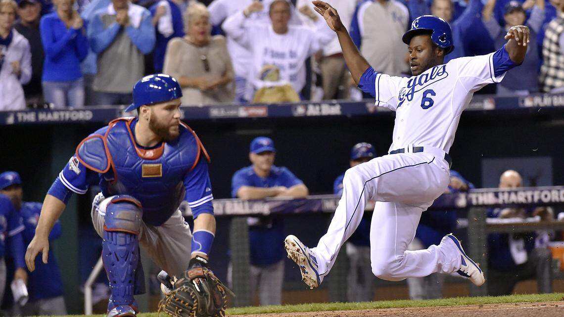 Kansas City Royals center fielder Lorenzo Cain scores past Toronto Blue Jays catcher Russell Martin on an RBI single by Kansas City Royals first baseman Eric Hosmer in the eighth inning during Friday’s ALCS baseball game on October 23, 2015 at Kauffman Stadium in Kansas City, Mo.