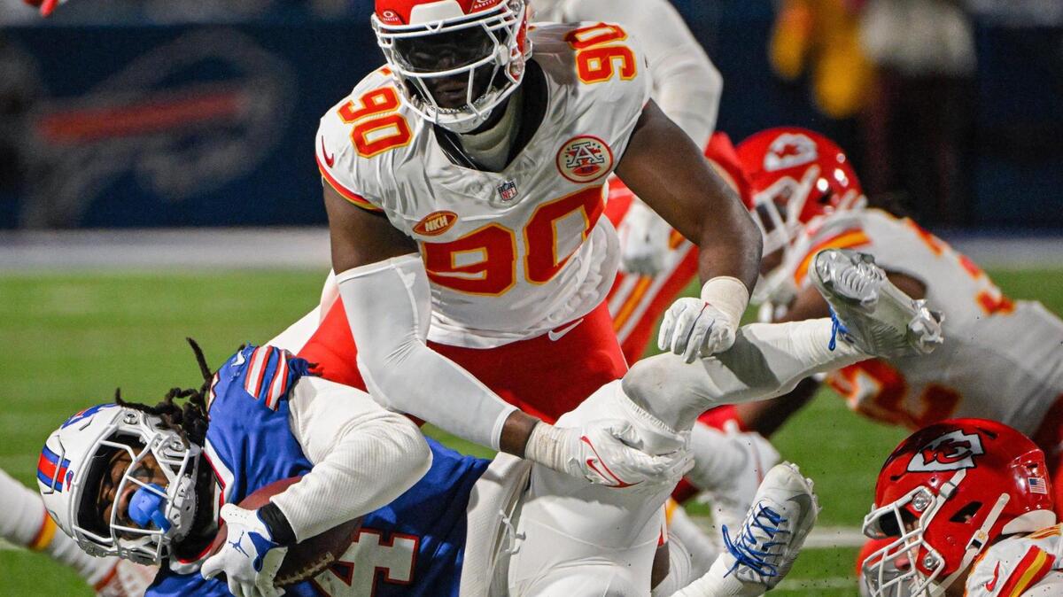 Kansas City Chiefs defensive end Charles Omenihu (90) helps stop Buffalo Bills running back James Cook (4) in the first half Sunday, Jan. 21, 2024, at Highmark Stadium in Orchard Park, New York.
