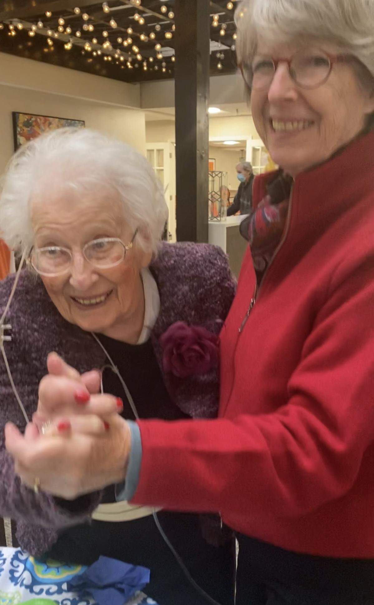 Gertrude Stern dances with her daughter-in-law, Mary Stern, during a party at The Atriums in February.