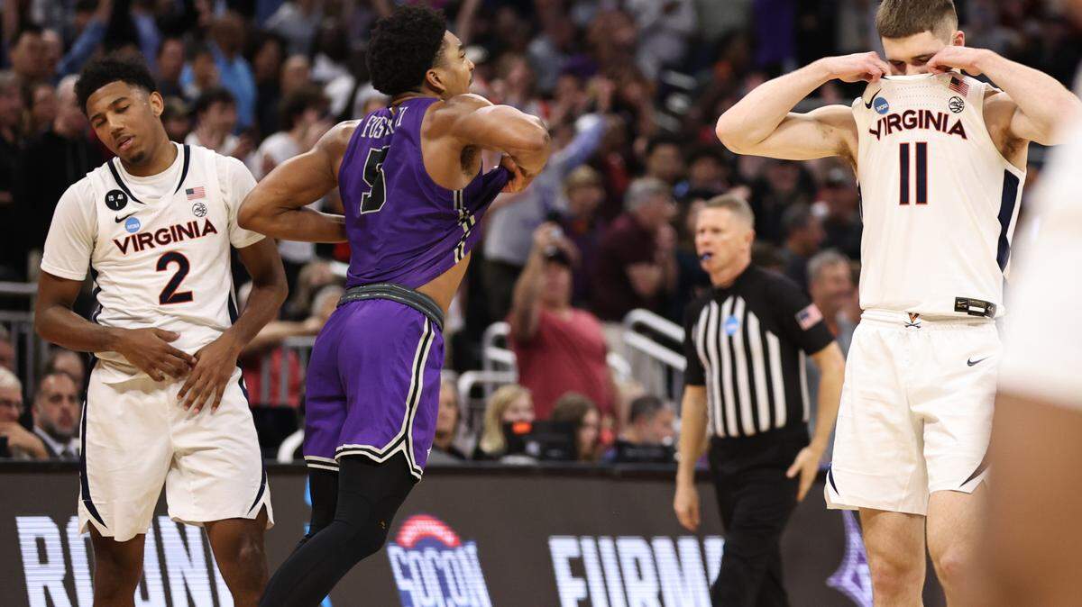 Mar 16, 2023; Orlando, FL, USA; Furman Paladins guard Marcus Foster (5) celebrates as Virginia Cavaliers guard Reece Beekman (2) and guard Isaac McKneely (11) react after the game at Amway Center. Mandatory Credit: Matt Pendleton-USA TODAY Sports