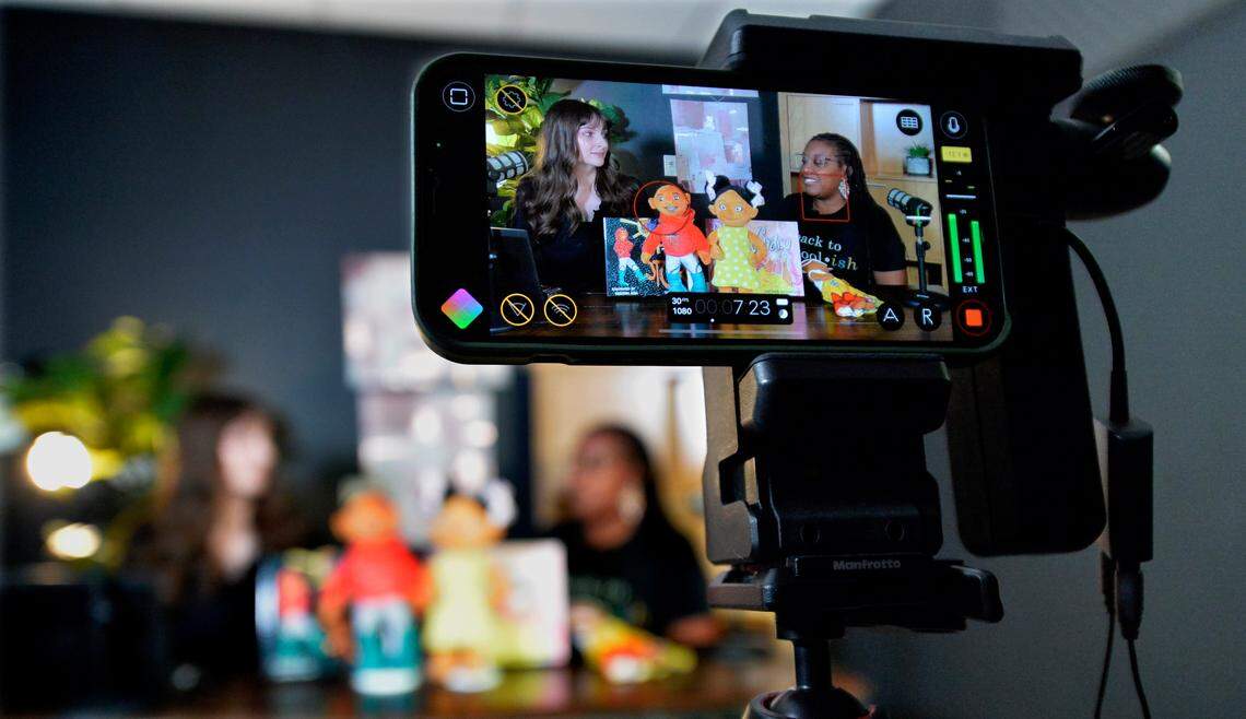 Dayonne Nicholas Richardson, right, owner of Mirror Mirror Books, talks with Kansas City Star reporter Sarah Ritter about her business in the studios of KC Gift.