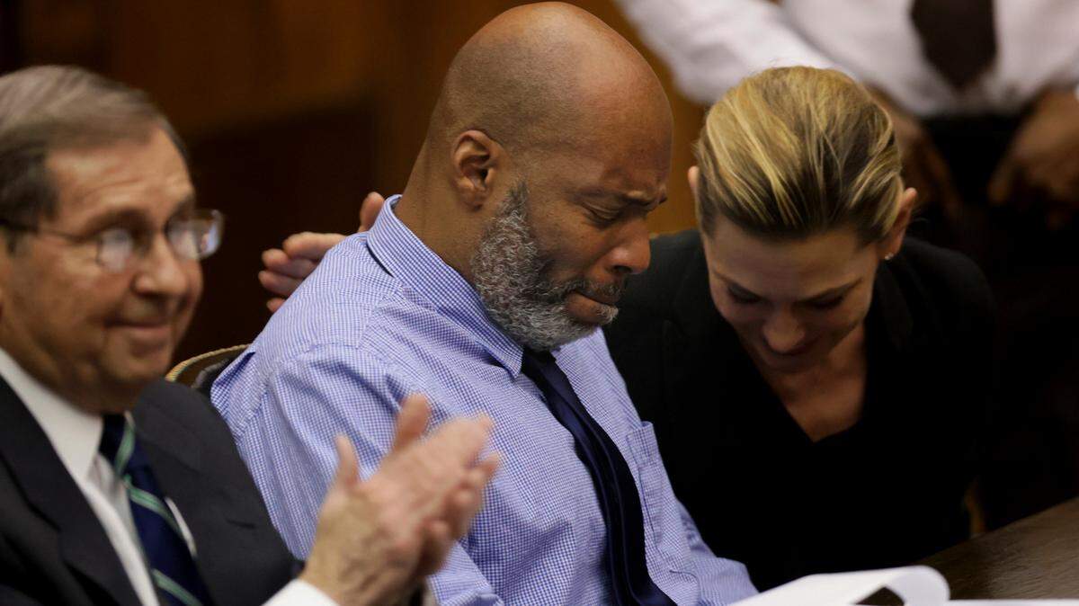 Lamar Johnson, center and his attorneys react on Tuesday, Feb. 14, 2023, after St. Louis Circuit Judge David Mason vacated his murder conviction during a hearing in St. Louis, Mo. Johnson served nearly 28 years of a life sentence for a killing that he has always said he didn’t commit.