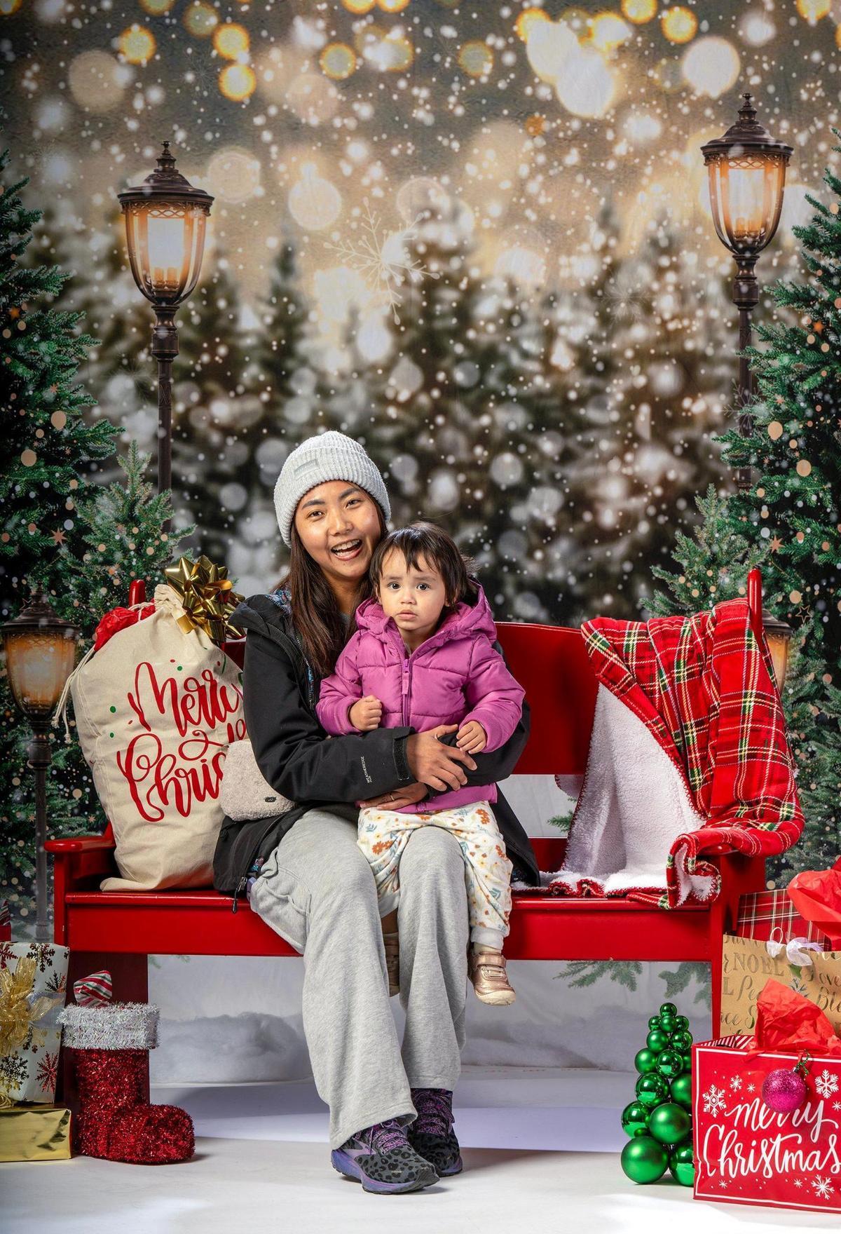 Moe Ourada and her daughter, Quinn Ourada, had their photo taken at the Plaza Branch Library on Thursday, Dec. 12, 2024 in Kansas City.