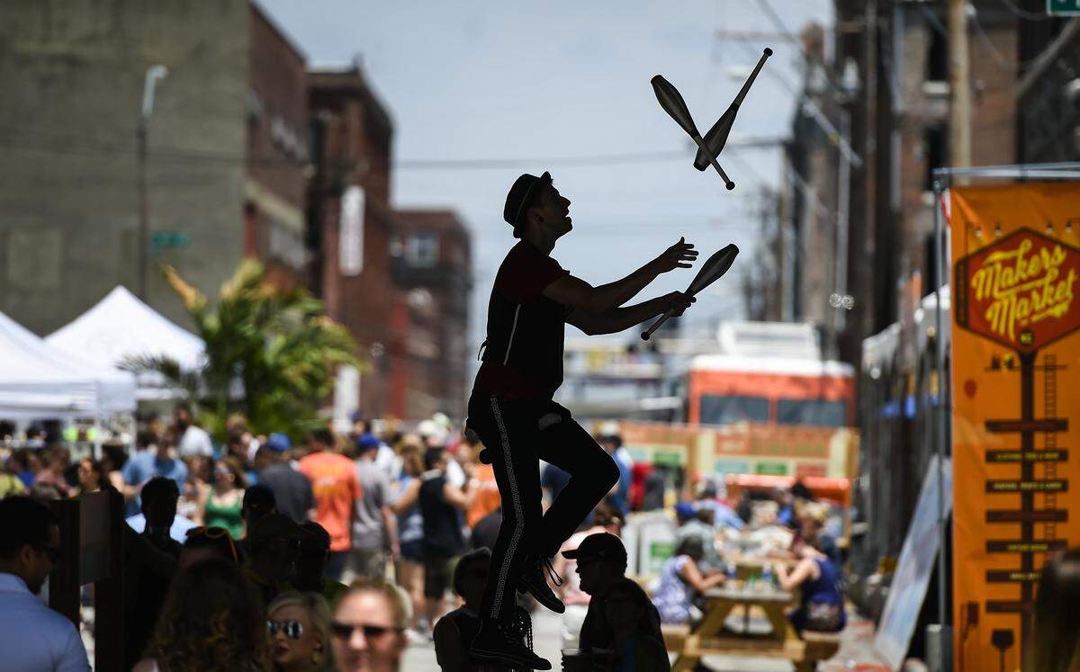 Jason Divad juggled on his seven-foot giraffe unicycle Saturday, June 18, 2016, at Boulevardia in the West Bottoms of Kansas City.