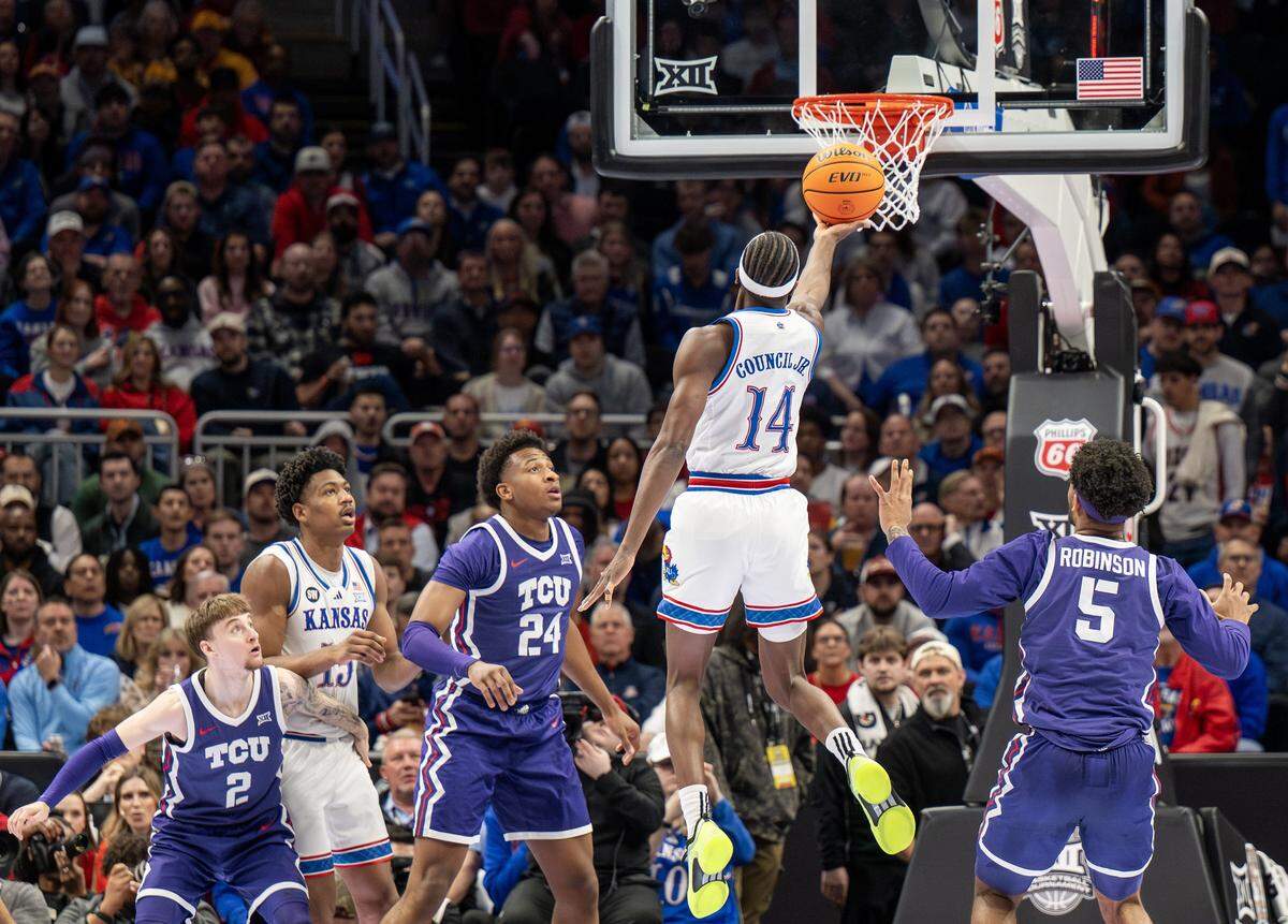 Kansas Jayhawks guard Melvin Council Jr. (14) makes a layup during the first half of a Big 12 Men's Basketball Tournament game against the Texas Christian University Horned Frogs at T-Mobile Center on Thursday, March 12, 2026, in Kansas City.