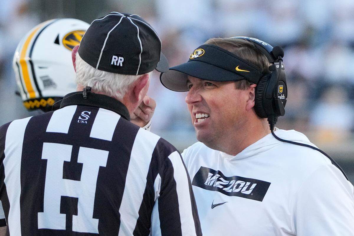 Missouri Tigers head coach Eli Drinkwitz, right, talks with an official during Saturday’s game against the Buffalo Bulls at Faurot Field at Memorial Stadium.