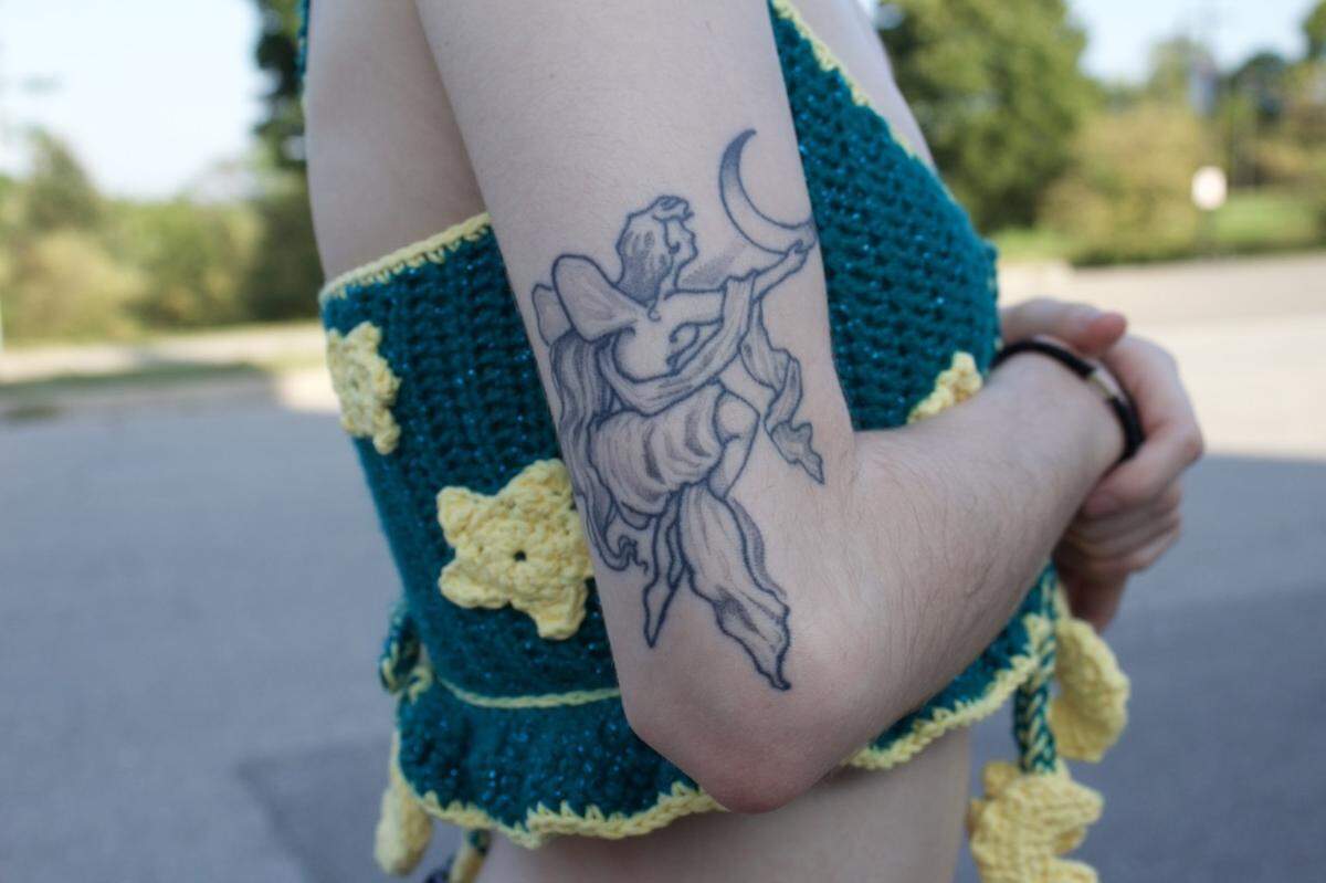 Two years after first hearing The Smashing Pumpkins’ song, “Mayonaise,” for the first time, Kiera Ainsworth, 23, got a tattoo inspired by the angel holding the planet Saturn, a character on the cover of the band’s 1995 album “Mellon Collie and the Infinite Sadness.” Ainsworth made the image in the tattoo her own, swapping the planet Saturn for a crescent moon.