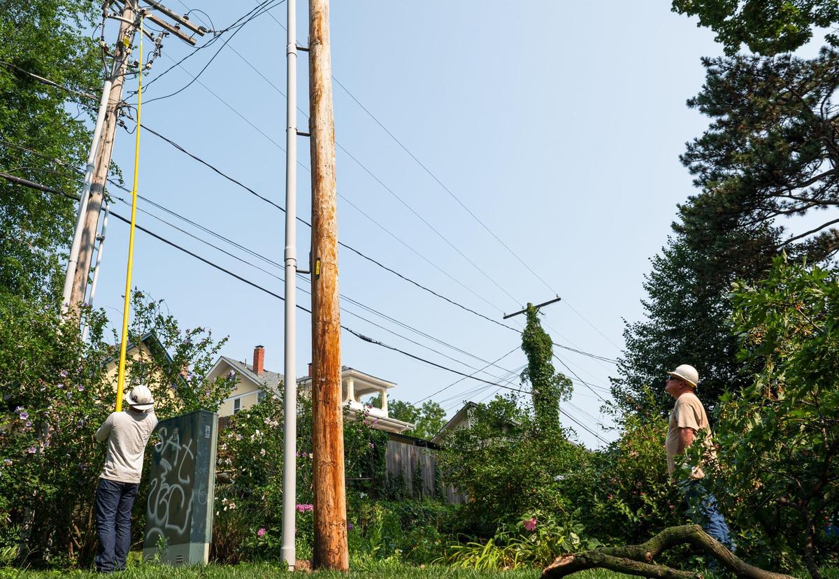 Evergy workers continued to restore power to residents in the Hyde Park neighborhood on Saturday, July 15, 2023, in Kansas City. More than 92,000 residents were without power on Saturday morning.