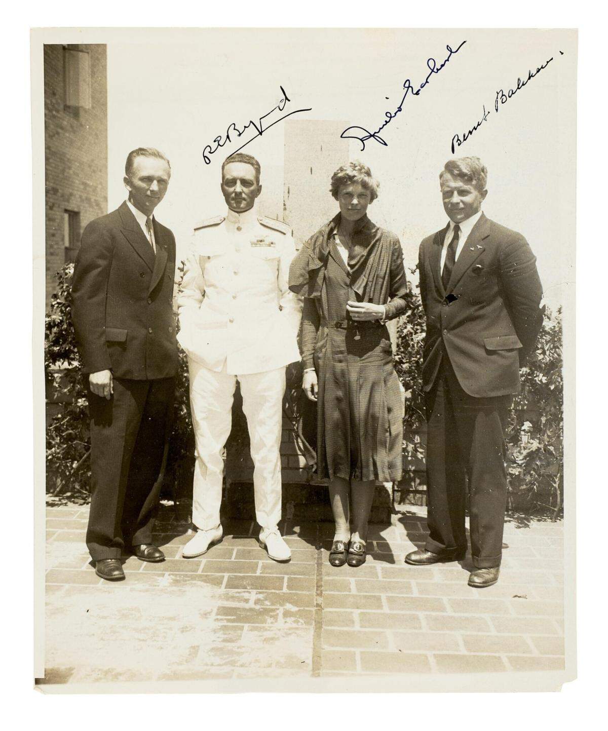 A photo of Amelia Earhart with explorers R.E. Byrd, second from left, and Bernt Balchen, far right, will be auctioned along with other Earhart photos.