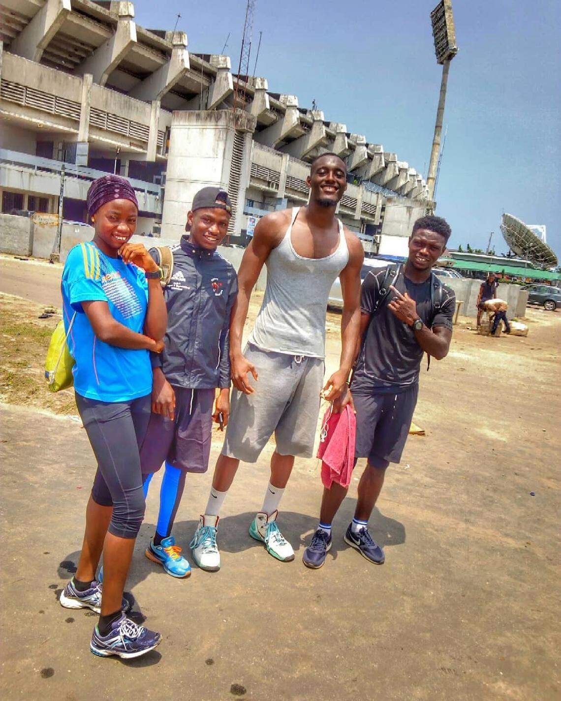 Kehinde Hassan Oginni poses with some young fans outside of National Stadium in Surluler, Lagos State, Nigeria.