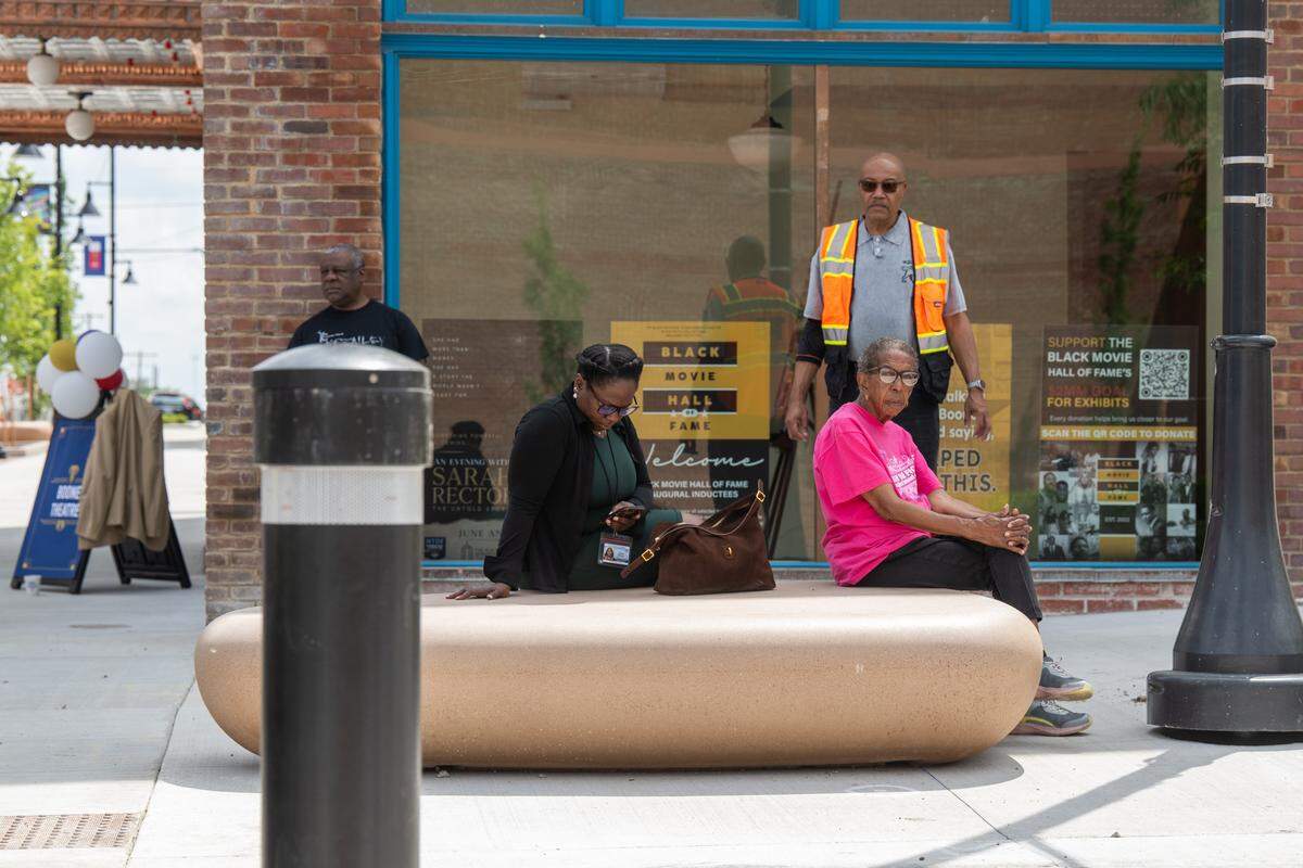 People utilize new seating options at the re-opening ceremony of the pedestrian mall in the 18th & Vine Jazz District on Wednesday, May 27, 2026, in Kansas City.