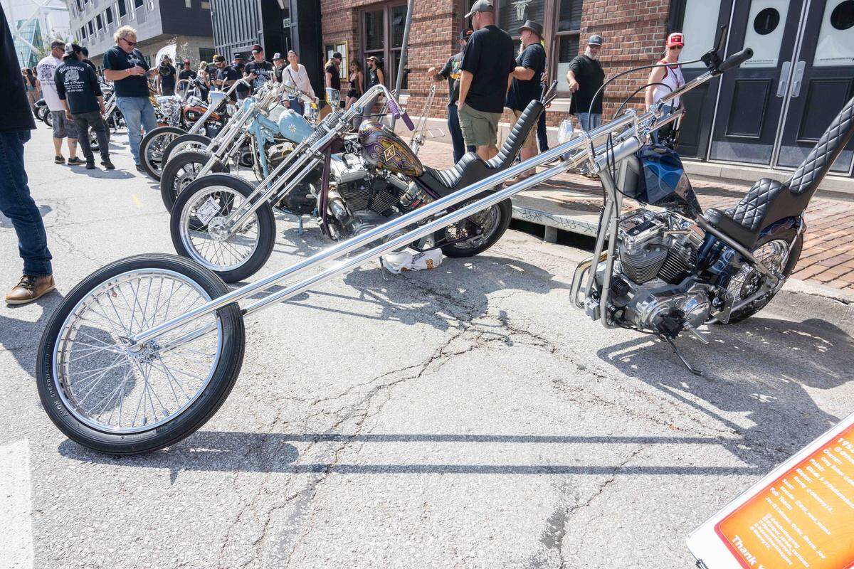 David Mann’s style included artwork showing custom motorcycles with elongated front forks.  Bike builders would copy elements seen in his artwork to create their own real life motorcycles.