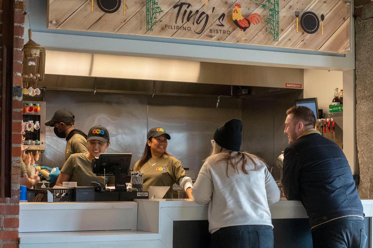 Theresa Santos-Spencer, center, welcomed customers Jan. 4 during the grand opening of her Ting’s Filipino Bistro in Parlor food hall.