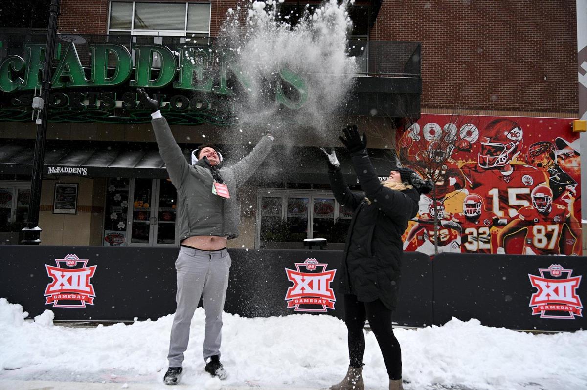 The Big 12 GameDay fan event outside the T-Mobile Center took a snow day Thursday, Mar. 10, 2022. Henry Powell of Knoxville, Tenn., and Courtney Bellavia of Tallahassee, Florida, with REBELxp, the company putting on the events, came out to the site to pass time. A fellow employee, Lisa Cunningham of Birmingham, Alabama, said they hoped to open later today but since snow was expected until Friday morning, opening might be delayed until then.