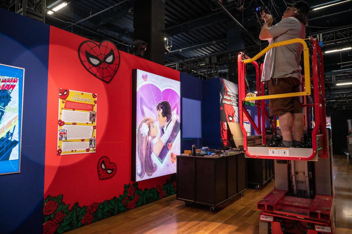 Crew members assemble lighting equipment during the ”Spider-Man: Beyond Amazing” exhibit set up Monday at Union Station.