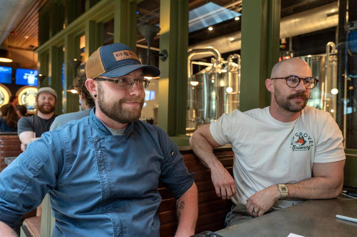 Topher Carpenter, left, Chef de Cuisine, and Tyler Carter, taproom marketing manager, discuss the upcoming opening of Big Grove Brewery in Prairie Village Thursday, May 14, 2026. The Iowa-based brewery and restaurant is set to open May 21 in the redeveloped Macy's building at 7060 Mission Rd.