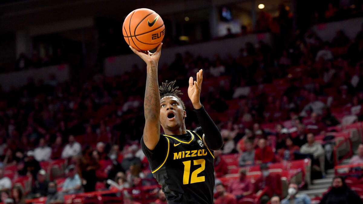 Missouri guard DaJuan Gordon (12) shoots over an Arkansas defender during the second half of an NCAA college basketball game Wednesday, Jan. 12, 2022, in Fayetteville, Ark. (AP Photo/Michael Woods)