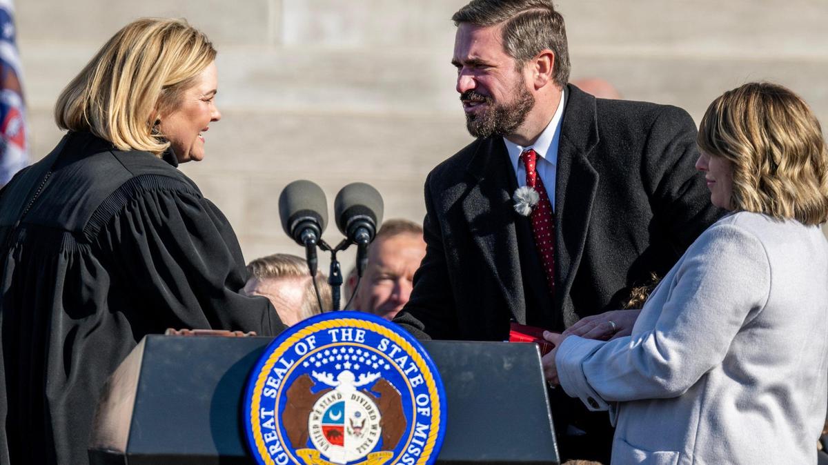Missouri Attorney General-elect Andrew Bailey shakes hands with Honorable Kelly Broniec, Judge of the Missouri Supreme Court, after being sworn in on the steps of the Missouri State Capitol on Monday, Jan. 13, 2025, in Jefferson City.