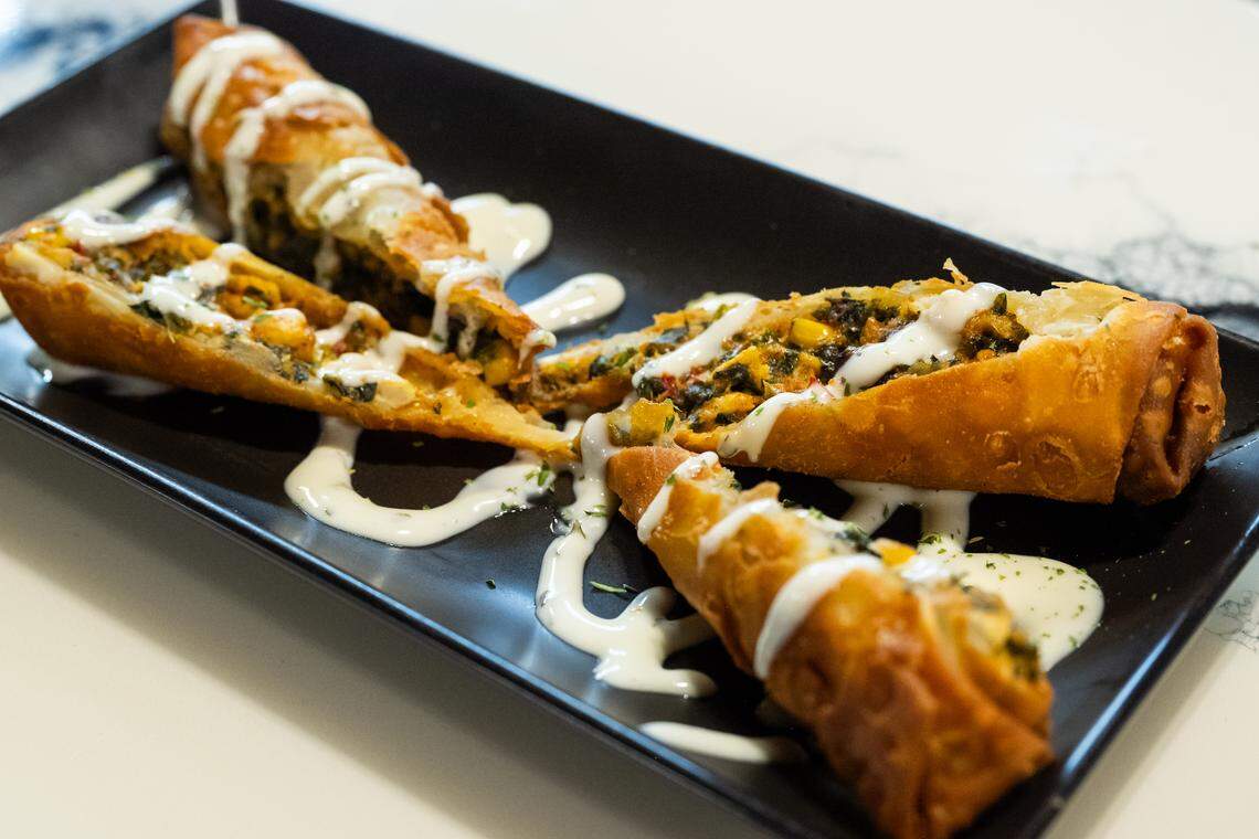 The Southwest Chicken Egg Rolls at Elevation Grille comes in four slices, with savory chicken inside that’s mixed with corn and beans with a drizzle of creamy sauce across the top.