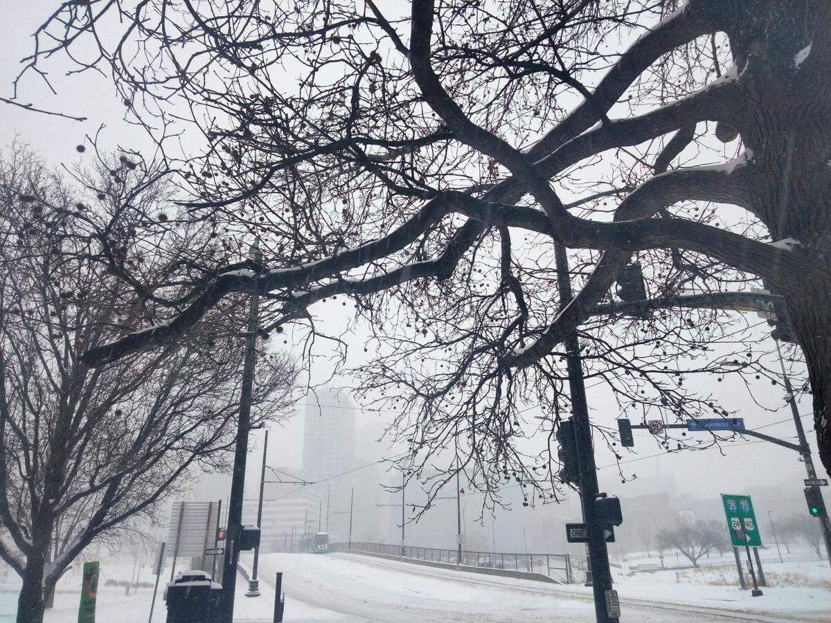 “A perfect snowy day in downtown Kansas City. The skyline is almost hidden by snow as the streetcar passes by, taken in the historic River Market neighborhood.” -Estella Luttrell