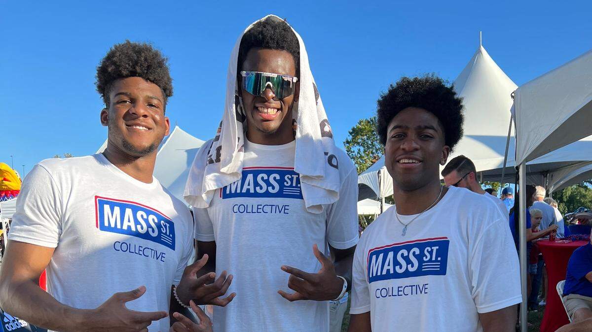 KU freshman basketball big men Ernest Udeh, center, and Zuby Ejiofor, left, pose with redshirt freshman guard Kyle Cuffe before a recent KU football game.